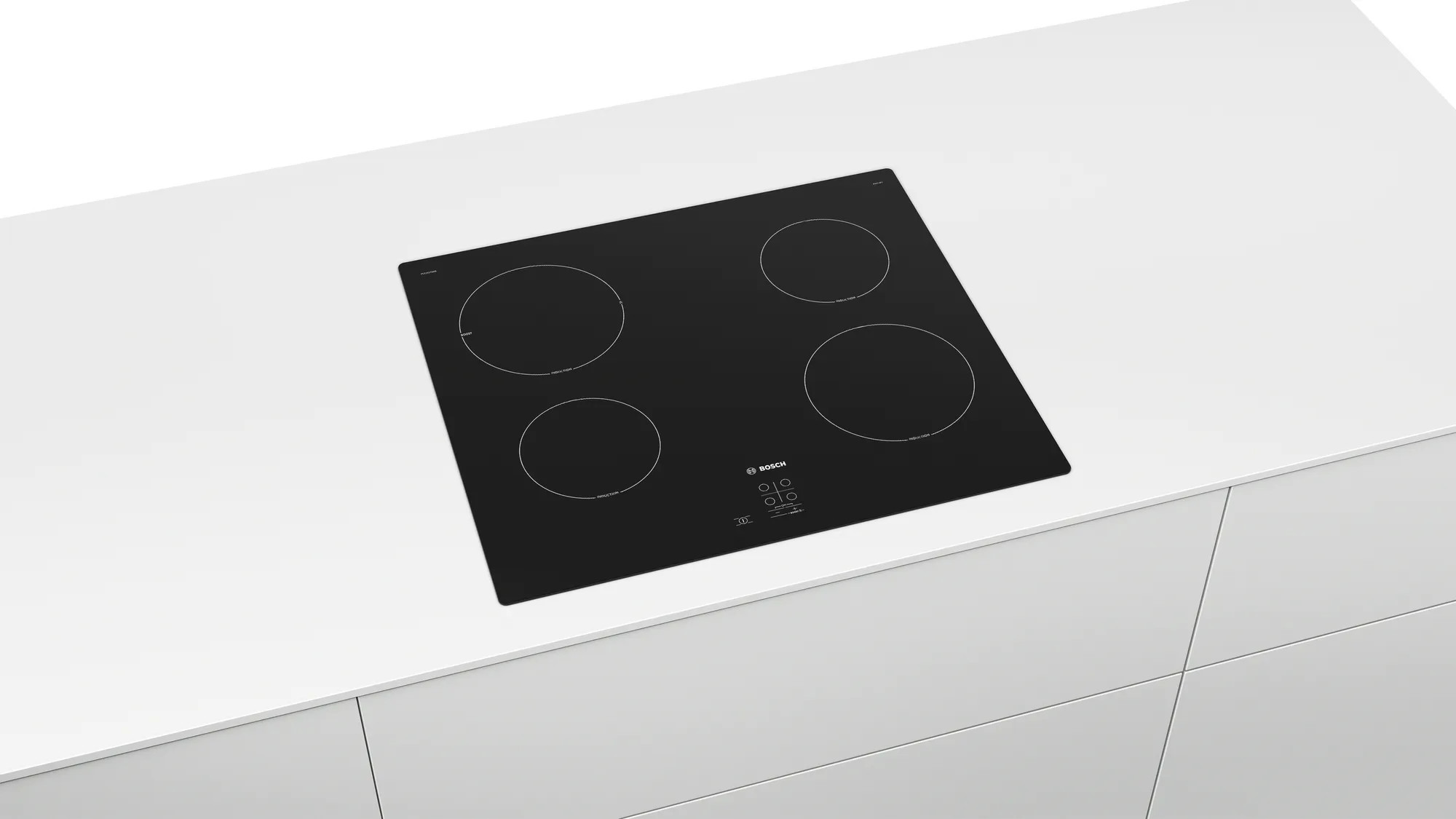 Une table de cuisson électrique noire avec quatre brûleurs circulaires sur un comptoir blanc.