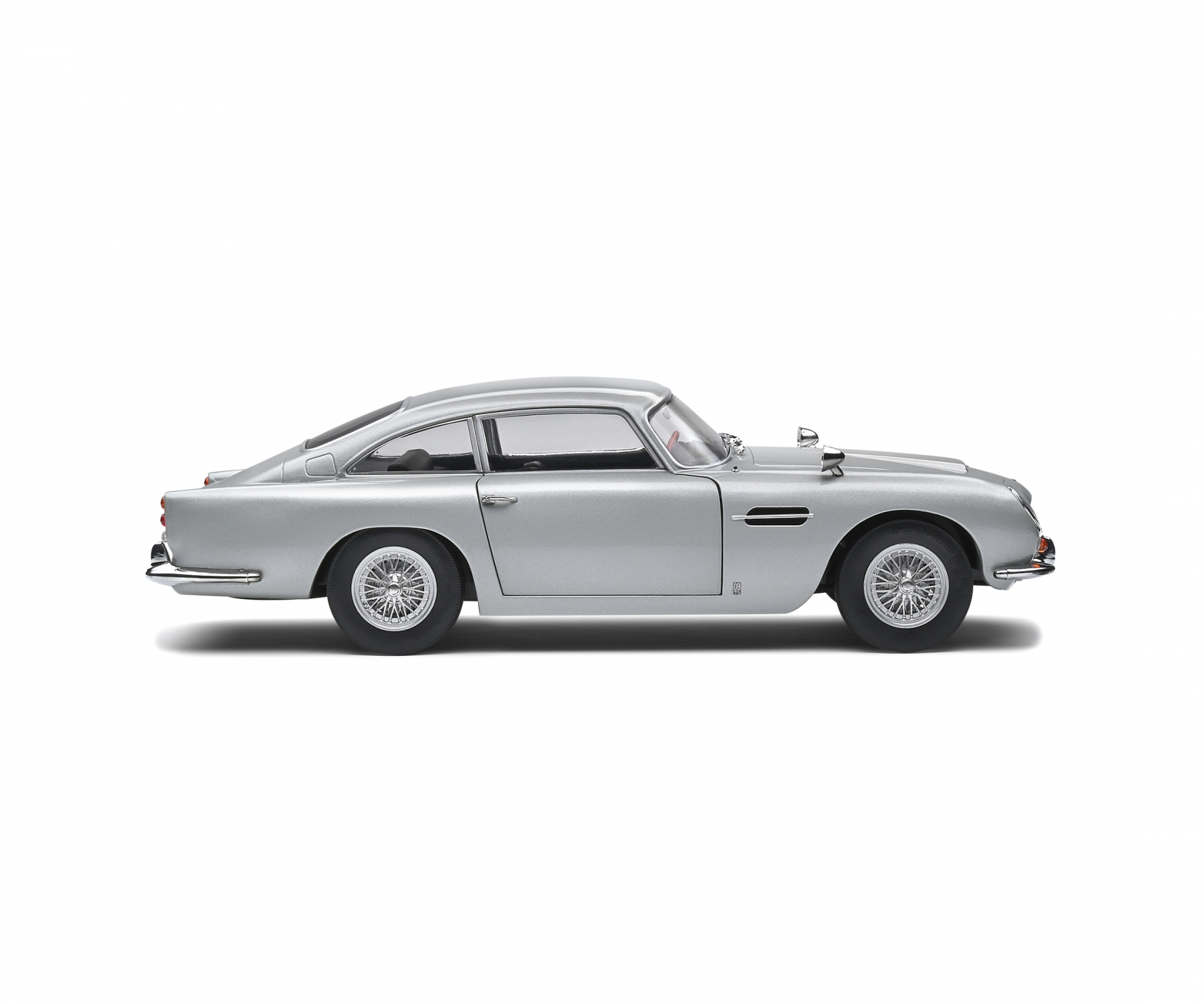 Silberner Klassiker vor weißem Hintergrund. Das Auto hat Drahträder und ein schlankes Design. Es ist ein Modell.