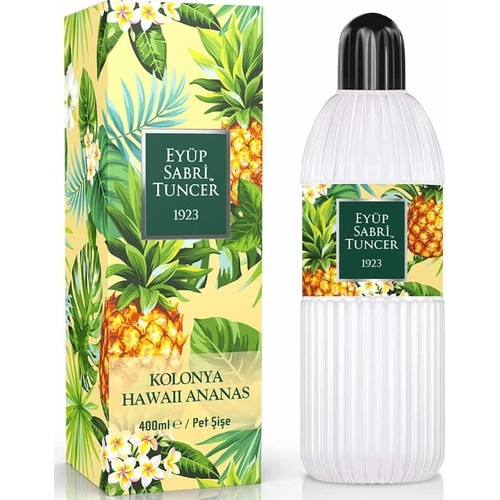 Ananas desenli bir kolonya şişesi, tropikal yapraklarla sarı bir kutuda paketlenmiş.