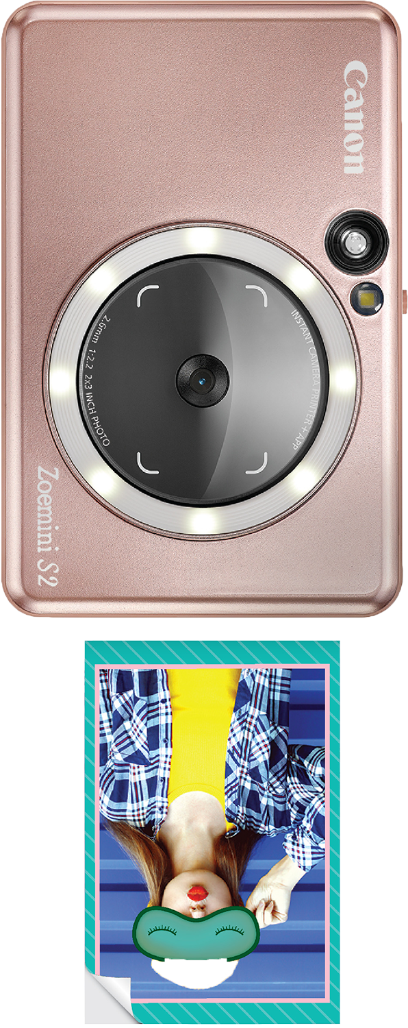 A Canon Zoemini S2 camera with an attached photo, rose gold color.