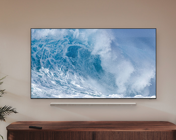 Tv met oceaangolven op een houten kast.