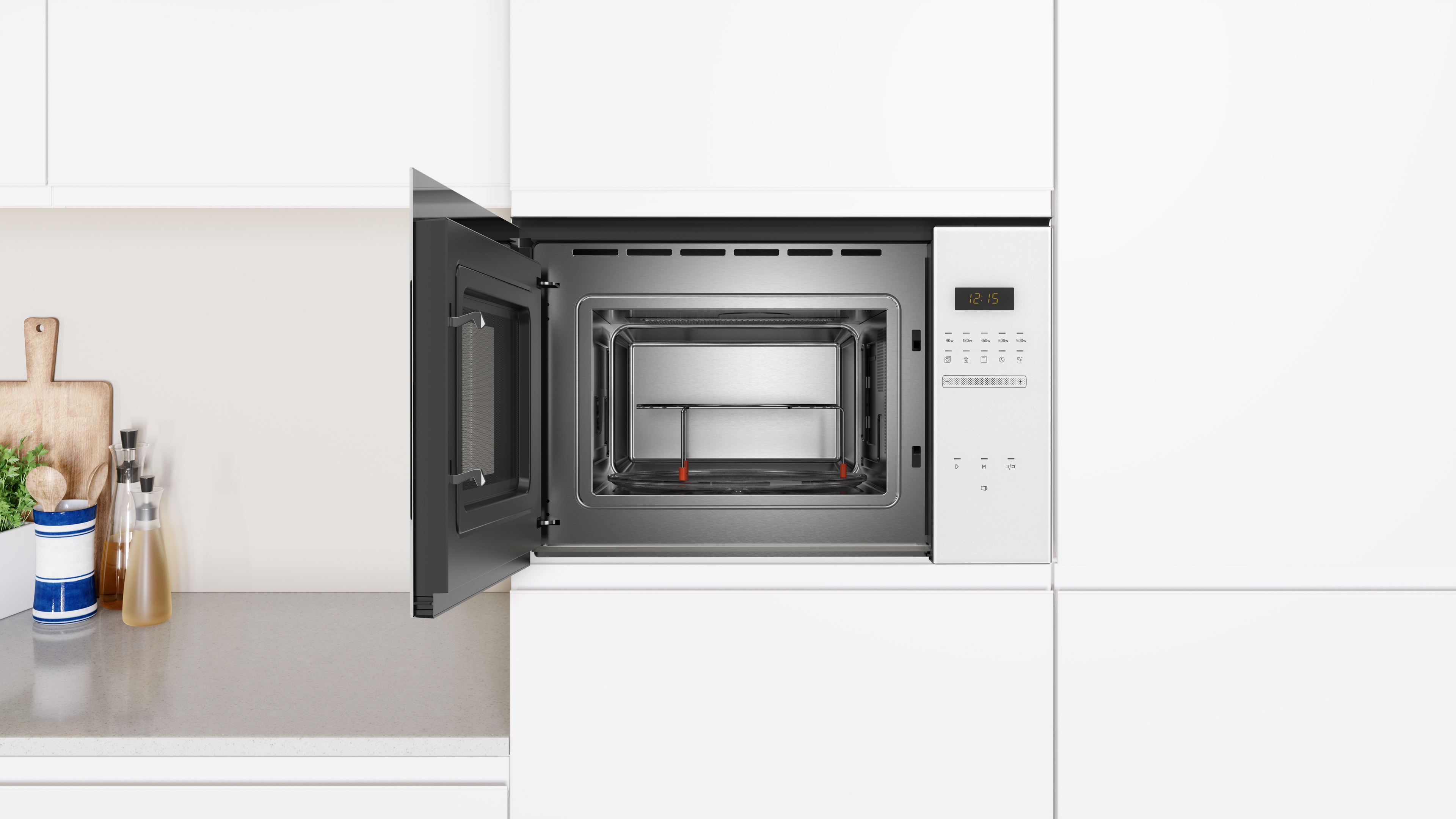 Un microondas empotrado con la puerta abierta. El interior es de acero inoxidable y el exterior blanco.
