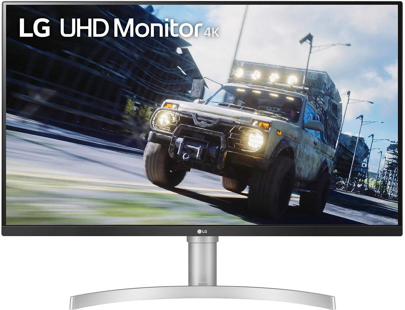 LG UHD Monitor 4K. Ein Auto fährt auf einer Straße vor dem Hintergrund einer Stadt und eines bewölkten Himmels.
