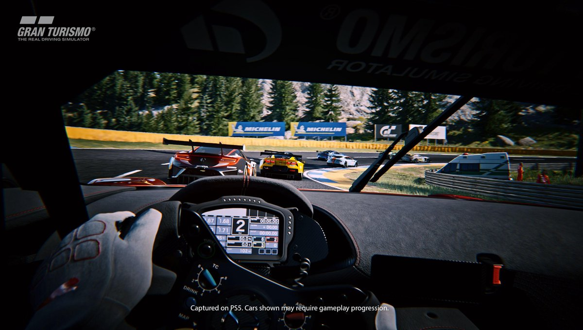 A racing car game view from inside the car on a race track.