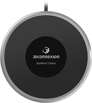 Egy 3Dconnexion SpaceMouse Compact fehér felületen. Fekete, kör alakú eszköz, központi logóval.