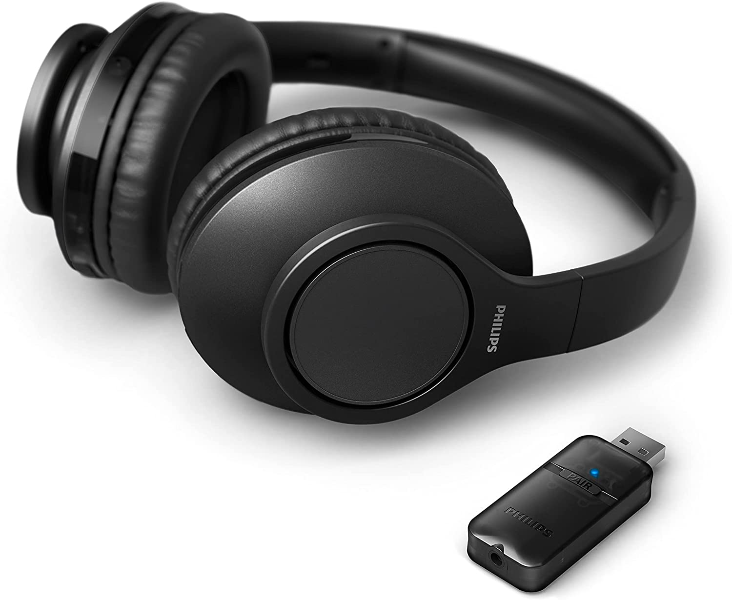 Casque sans fil noir et un récepteur USB noir sur une surface blanche.