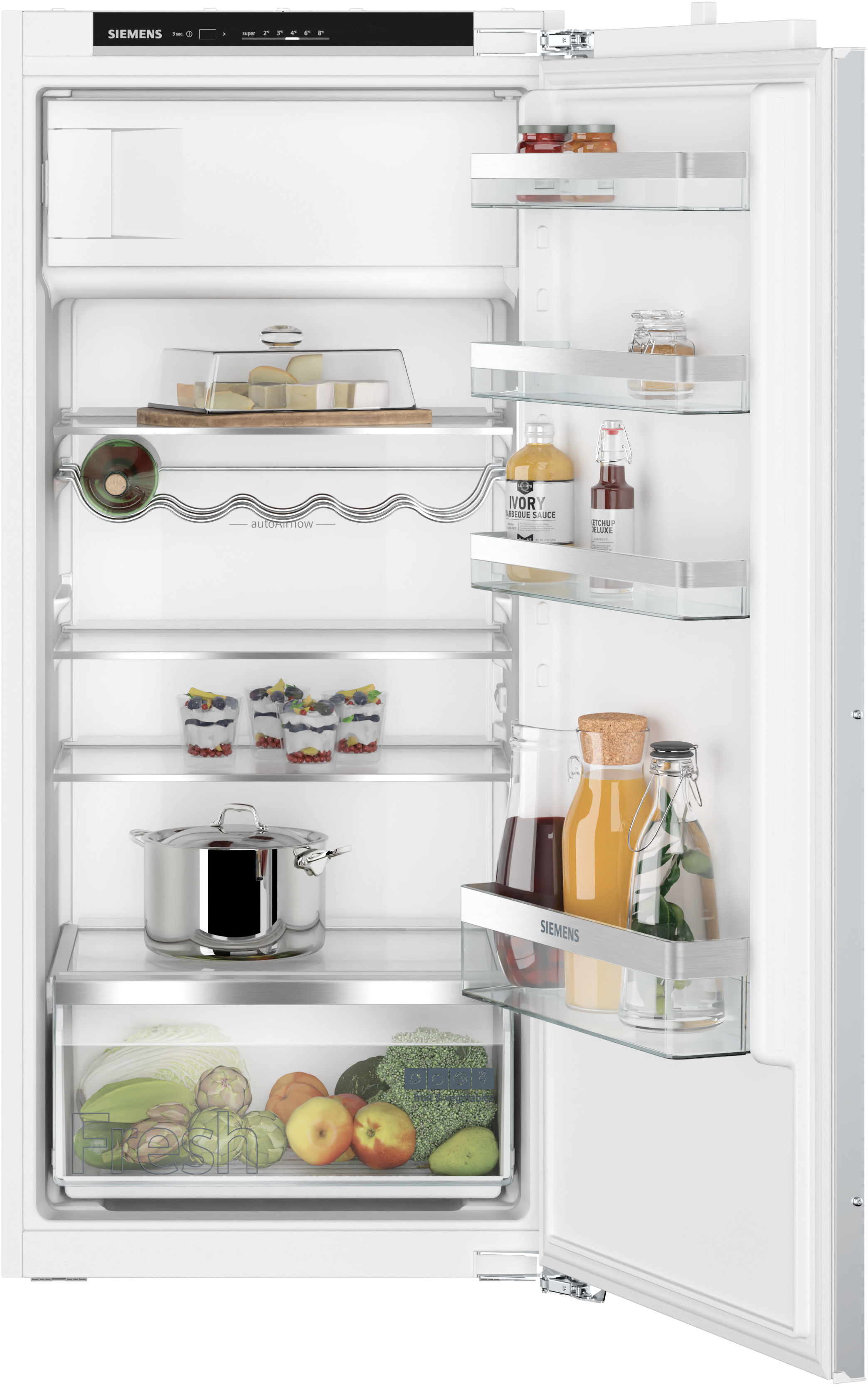 Open fridge with food: fruit, vegetables, jars, and containers on glass shelves.