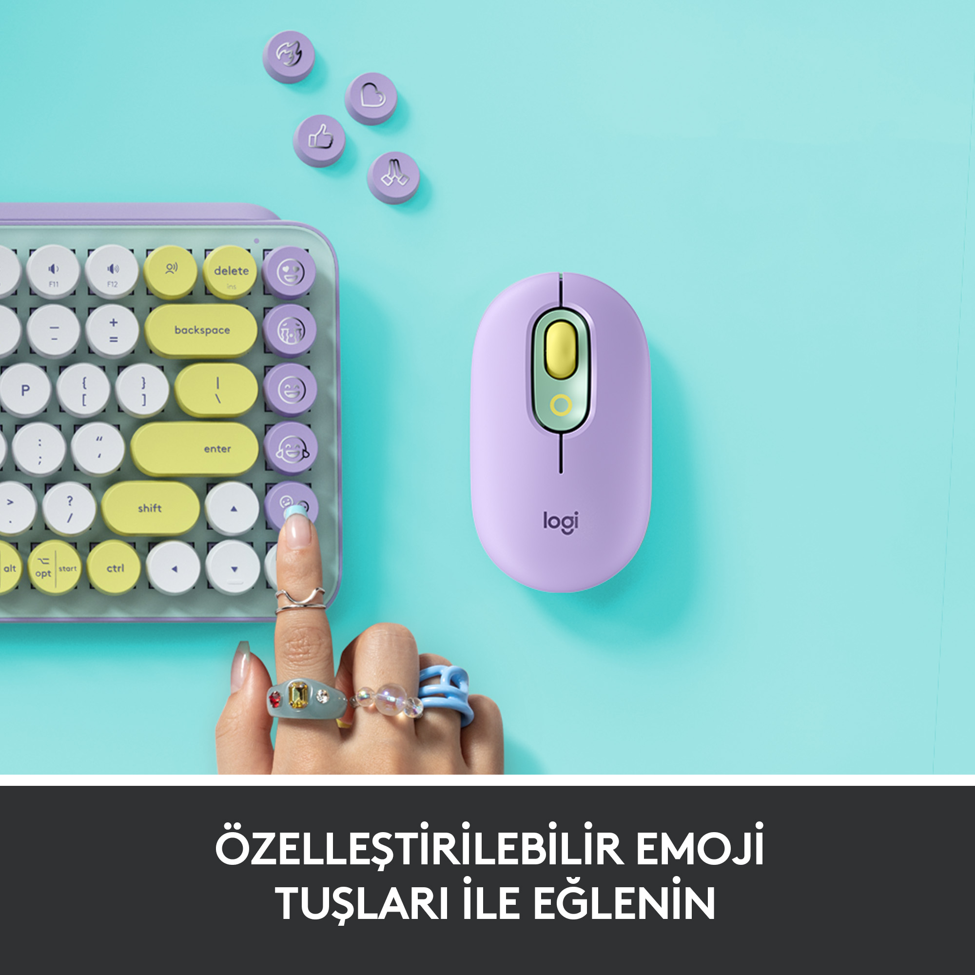 Bir masada bir klavye ve fare. Klavye, emoji tuşlarıyla birlikte açık mor renktedir.