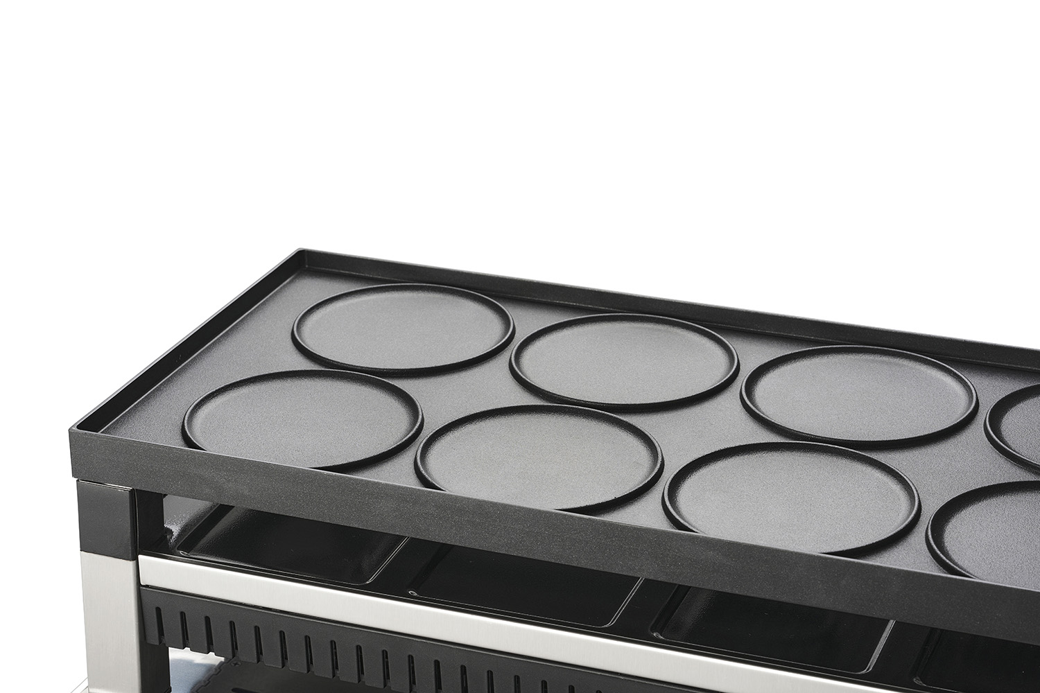 Een zwarte bakplaat met ronde kookoppervlakken. Het staat op een metalen rek.