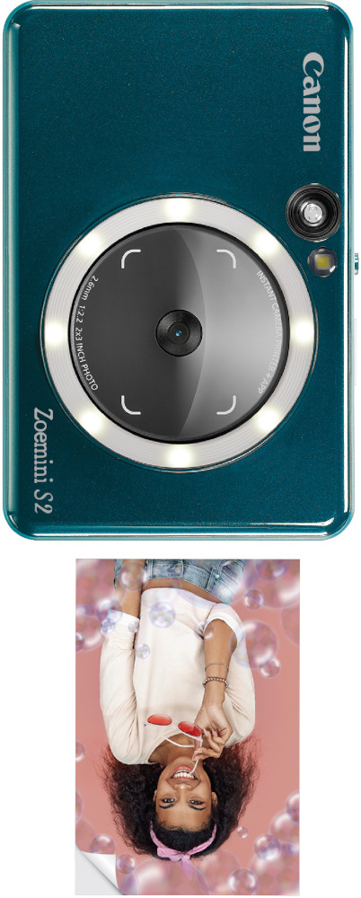 A teal Canon camera, with a selfie of a girl blowing bubbles. 