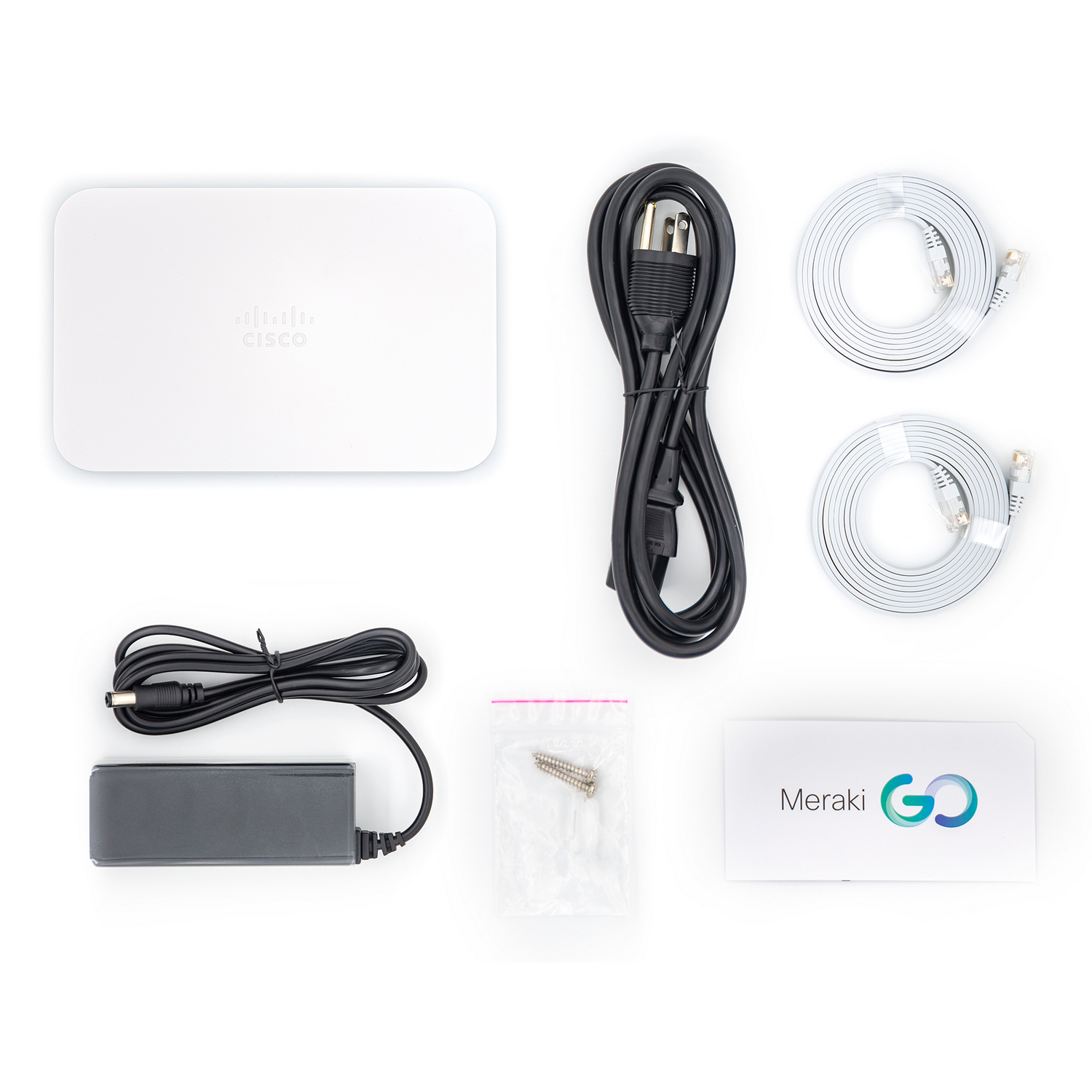 Caja de router Cisco blanca con cable de alimentación, cables Ethernet y caja Meraki Go.