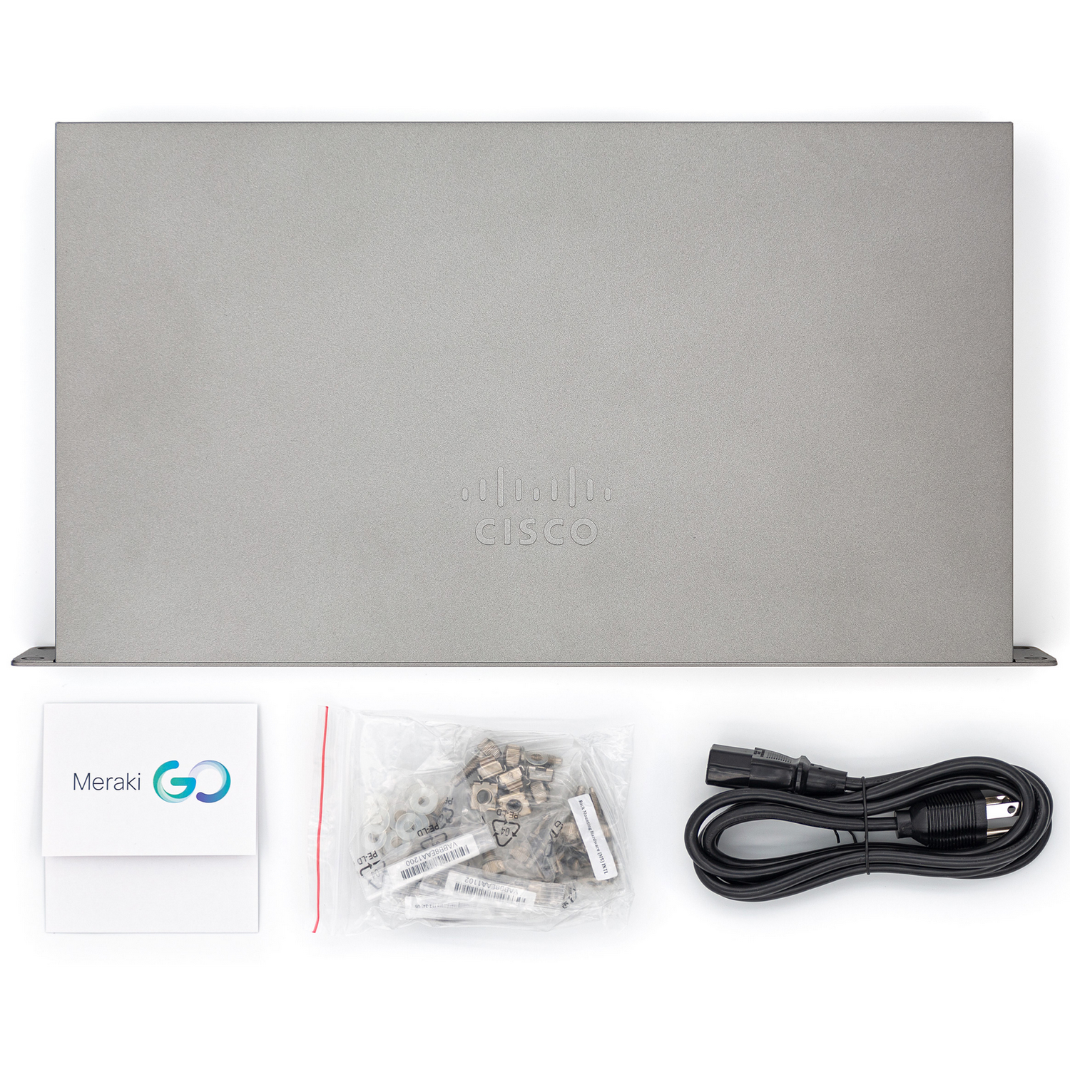 Vista superior de un servidor gris con accesorios: cables, tornillos y una caja Meraki GO.