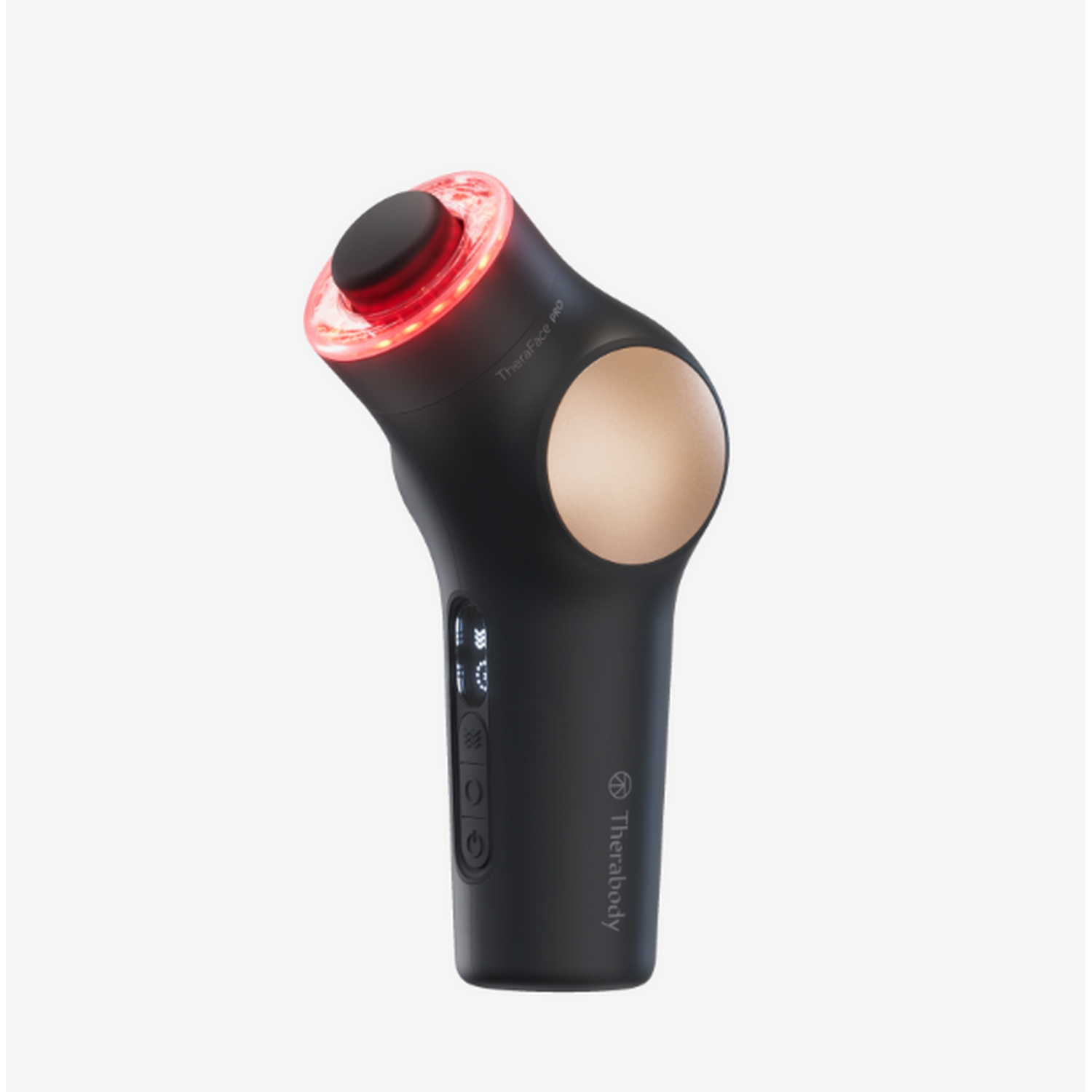 Un dispositivo Theraface Pro negro con luz roja en la parte superior, sobre una superficie blanca.