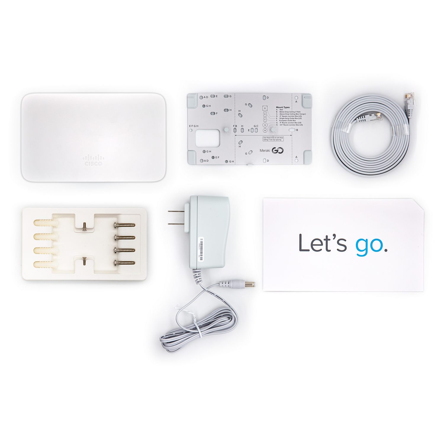 Kit de enrutador Cisco blanco con varios componentes sobre una superficie blanca.