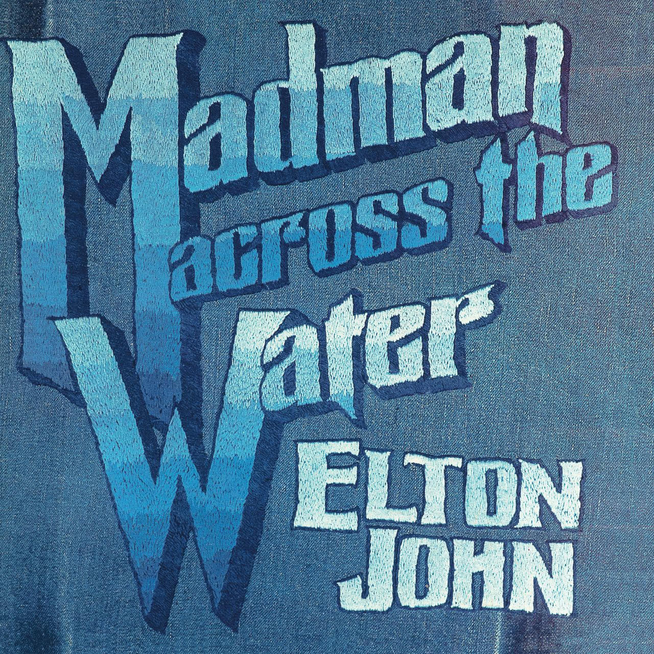 Elton John Albumcover mit blauem und weißem Text auf denimartigem Hintergrund.