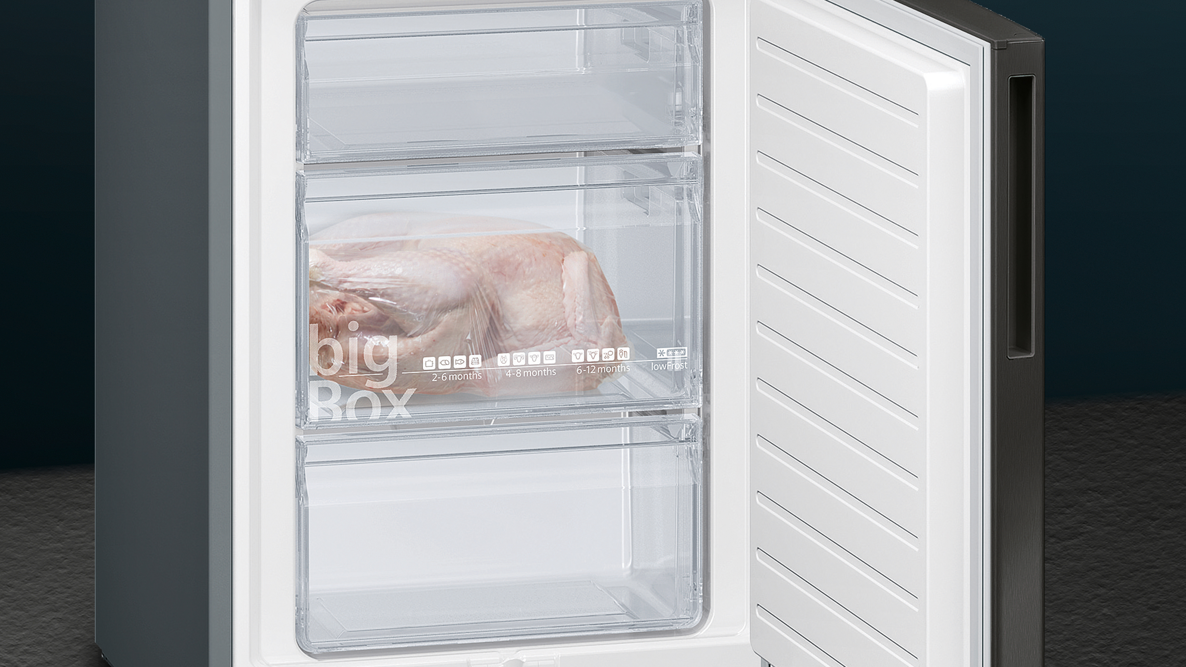 Freezer with three compartments, one with a frozen chicken in a Big Box container.