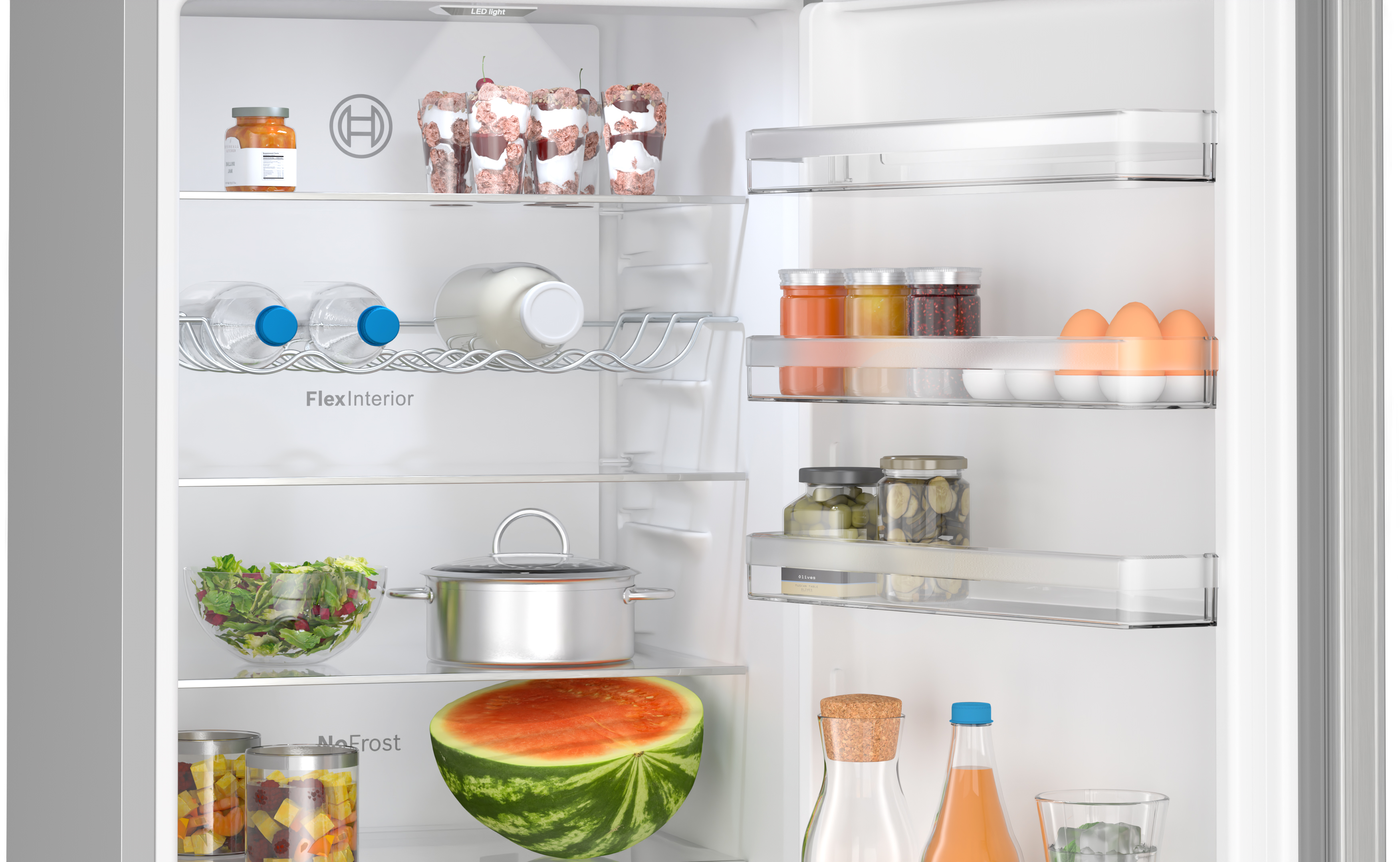 Open refrigerator filled with food items: jars, water bottles, salad, watermelon, eggs.