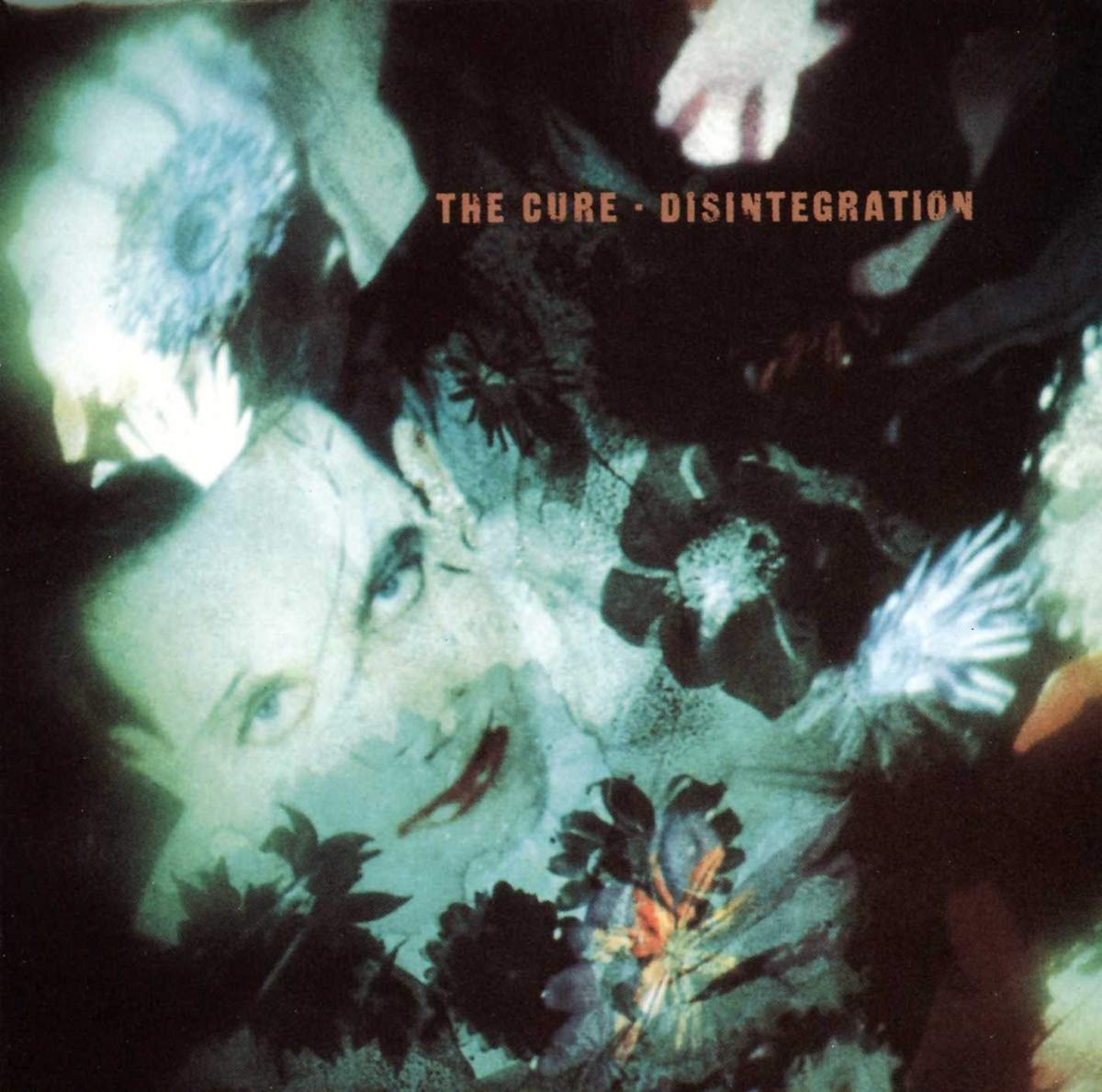 Album borító: absztrakt kép arcokról és virágokról, 'The Cure-Disintegration' szöveg.