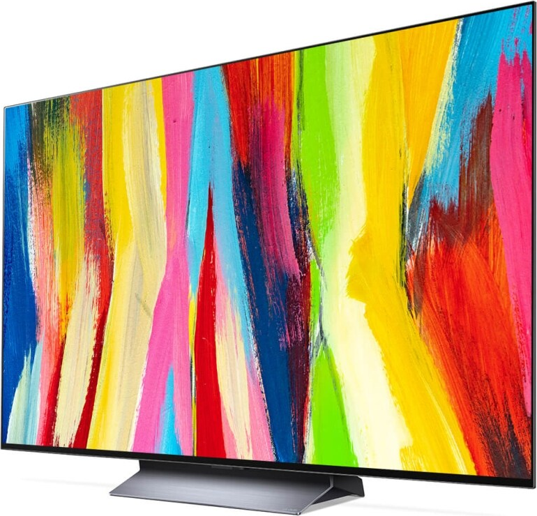 Ein farbenfroher Fernsehbildschirm mit einer hellen, abstrakten Anzeige. Der Fernseher steht auf einem Ständer.