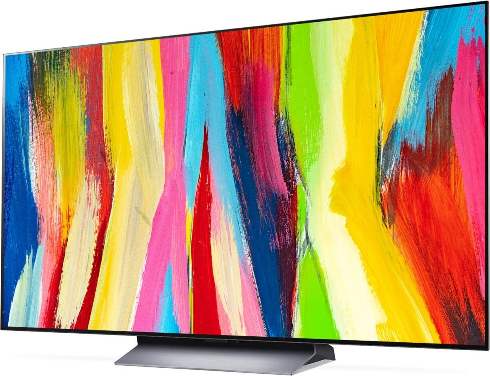 Großer TV-Bildschirm mit abstrakter, farbenfroher Kunst.