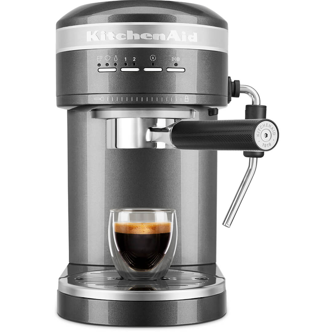 Szürke KitchenAid eszpresszógép egy pohár kávéval előtte.