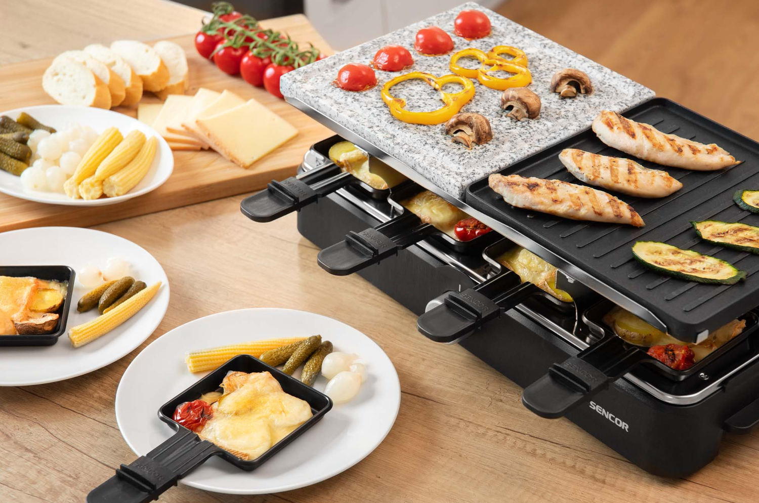 Egy asztal étellel és egy raclette grill sajttal és hússal.
