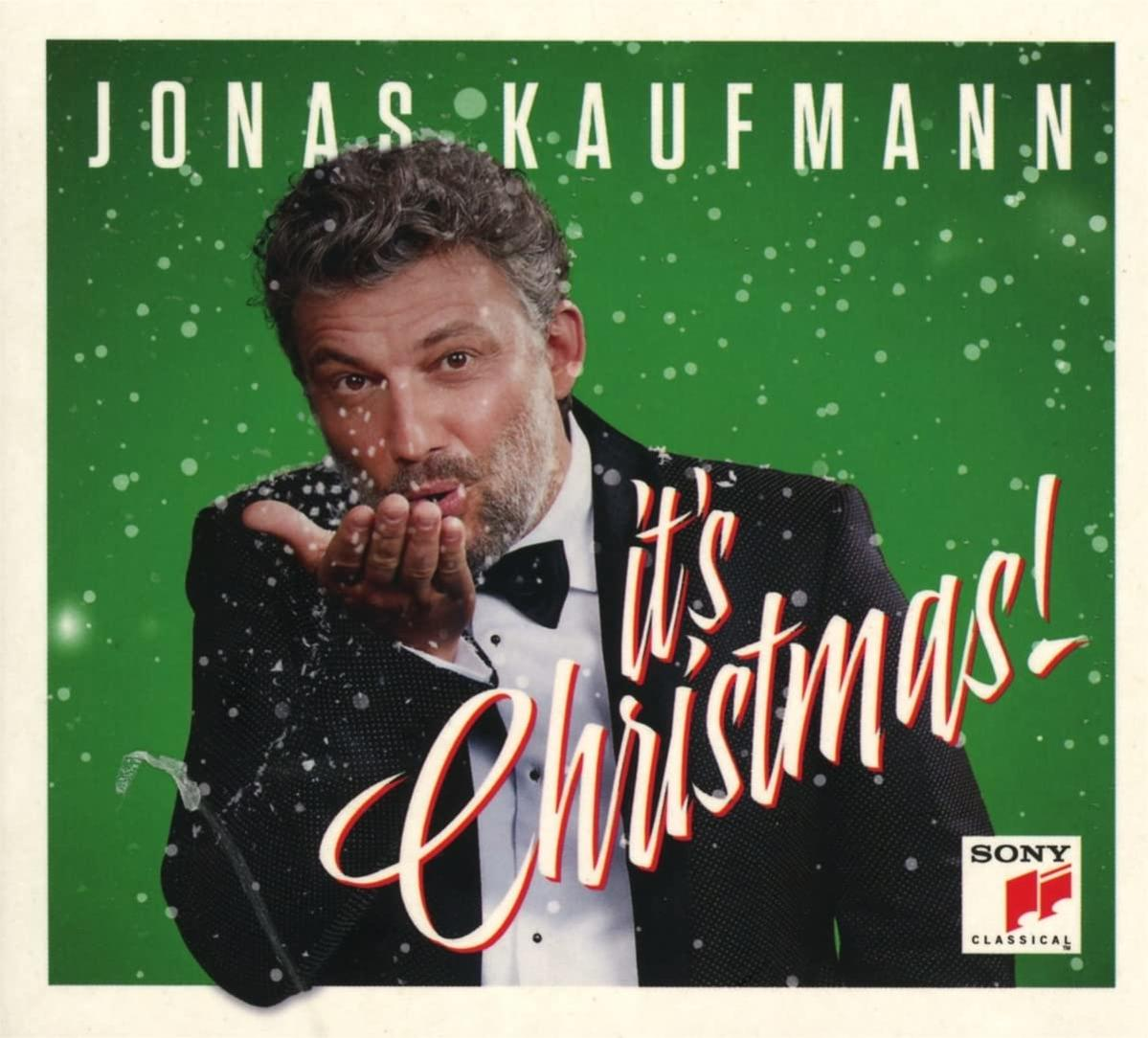 Mann, der Glitzer pustet. Grüner Hintergrund, Text "It's Christmas!" und CD-Cover.