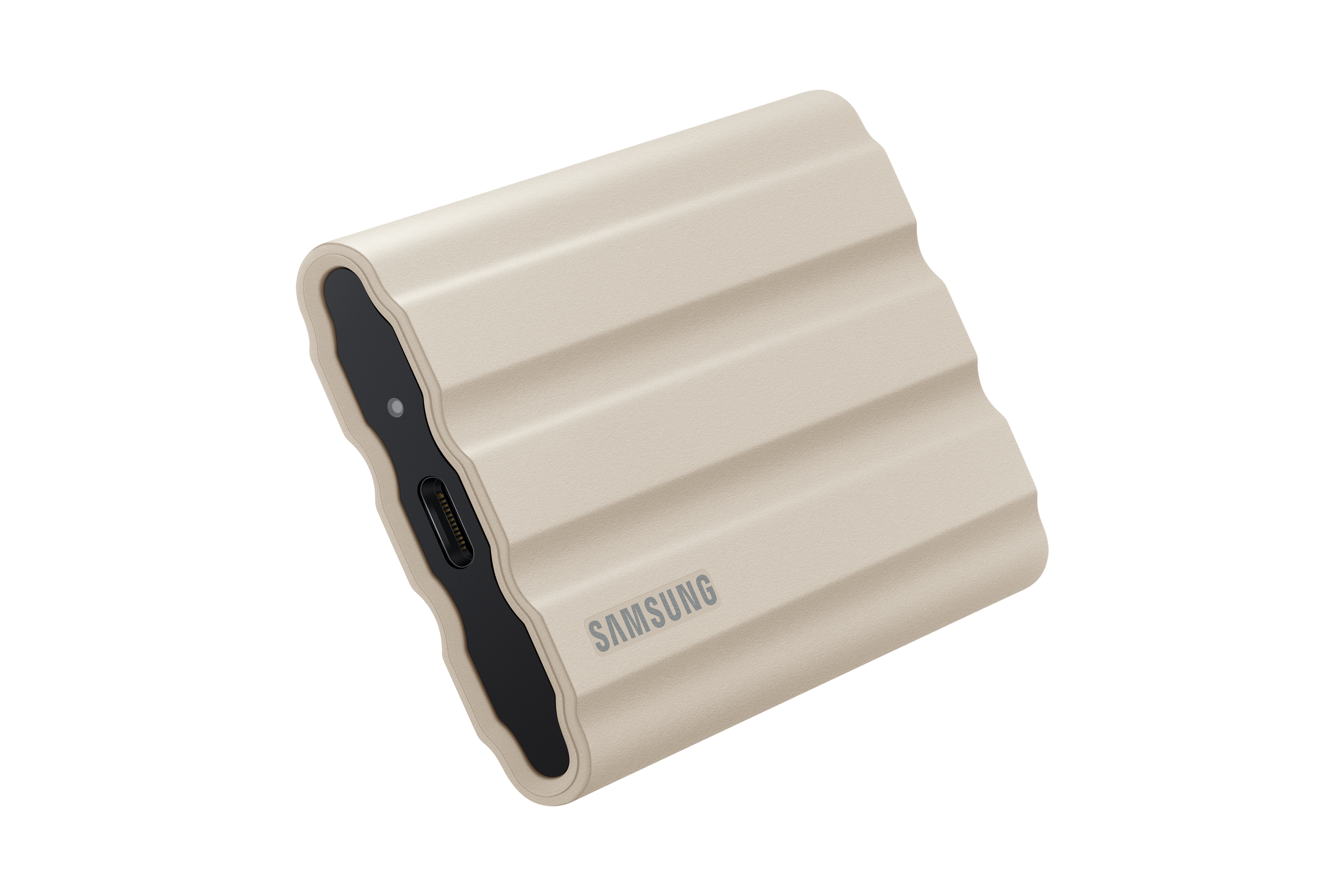 Beige draagbare harde schijf op een zwarte achtergrond. Het apparaat heeft een geribbeld ontwerp en het Samsung-logo.