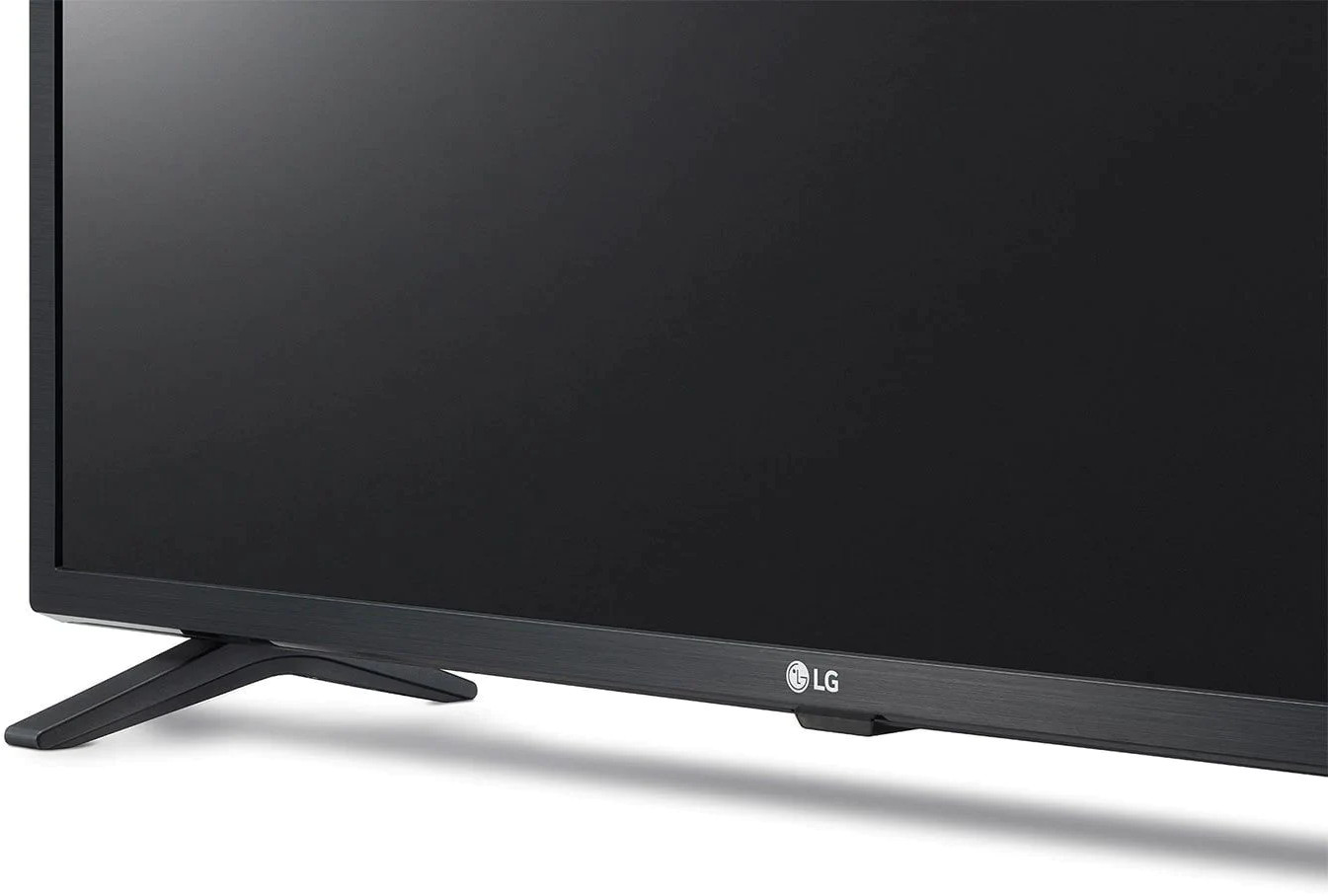 Black LG TV, close-up of the bottom with legs and the LG logo on a white surface.