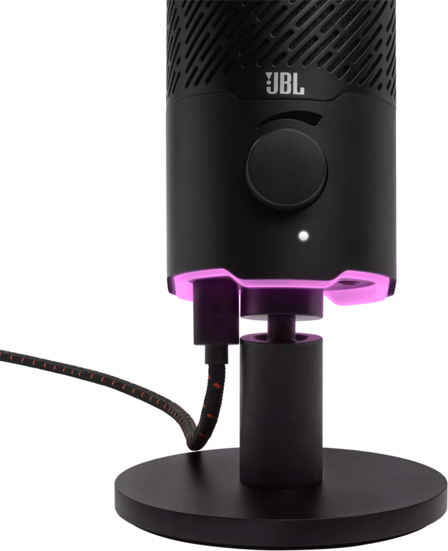 Egy fekete JBL mikrofon ragyogó rózsaszín alappal, közelről.