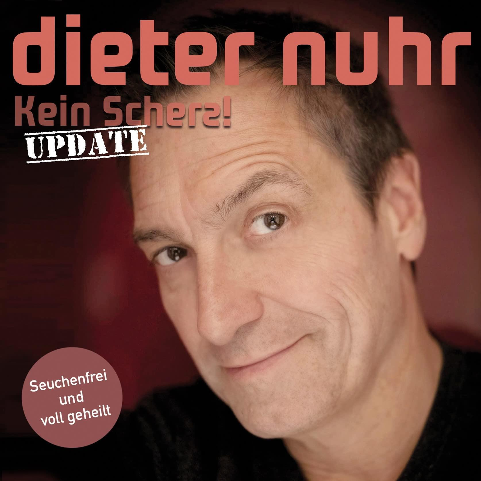 Nahaufnahme eines Mannes mit kurzen Haaren, der lächelt. Der Text oben lautet 'dieter nurh' und 'Kein Schertz! UPDATE'.