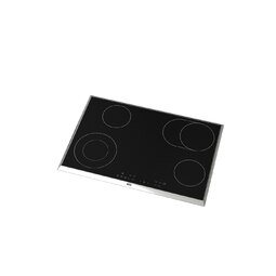 Black induction cooktop with four circular cooking zones, silver frame, isolated on white.