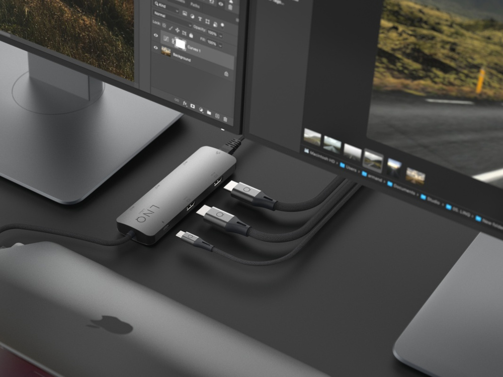 Un hub avec des câbles USB connectés à un ordinateur portable et des moniteurs.