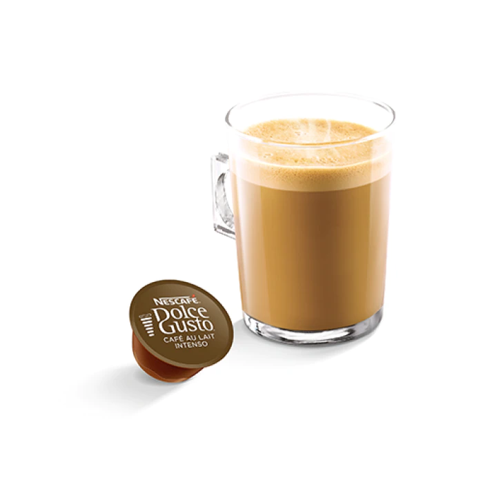 Un bicchiere di caffè con latte. Una capsula di caffè è posizionata accanto.