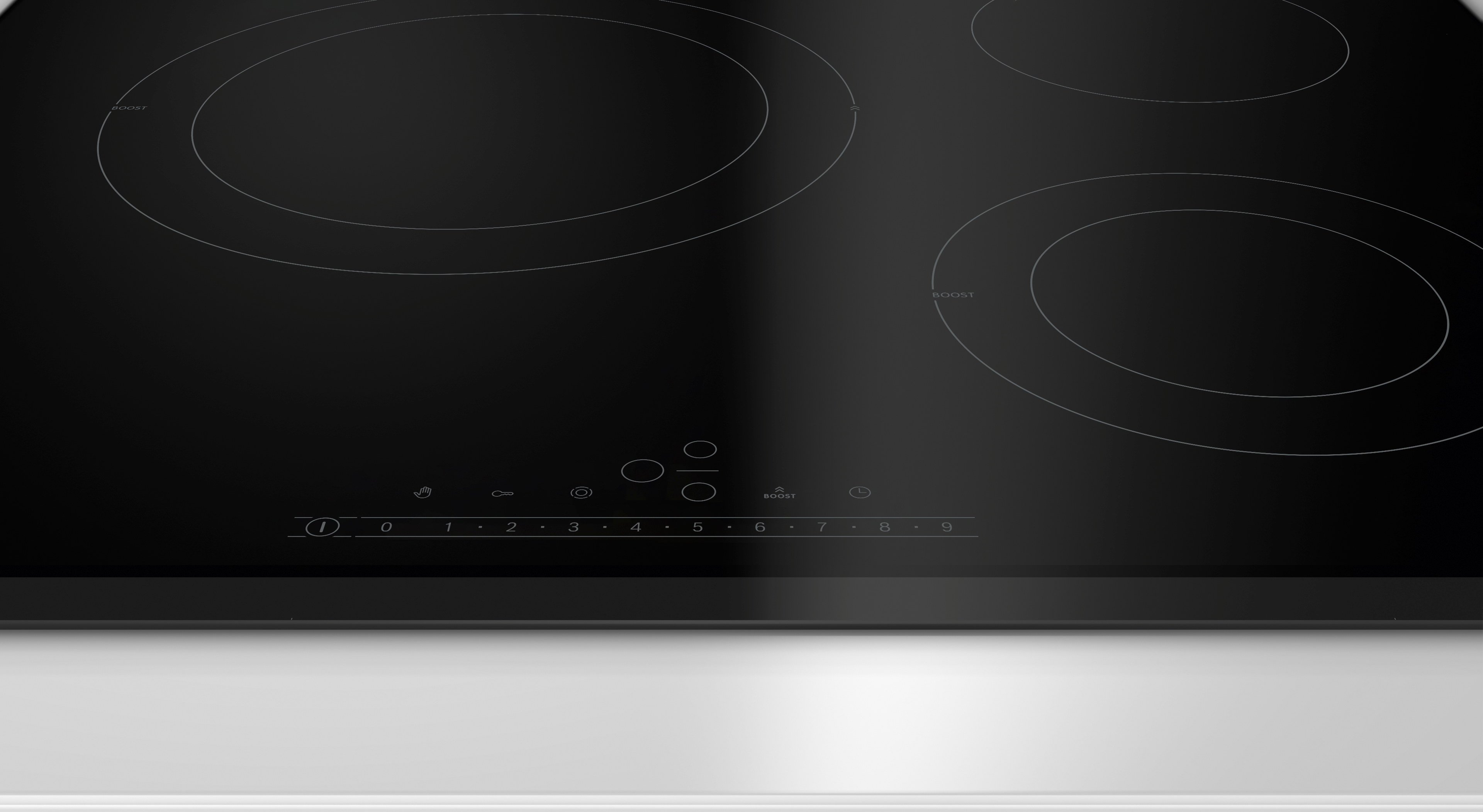 Primer plano de una placa de inducción negra con controles táctiles numerados.