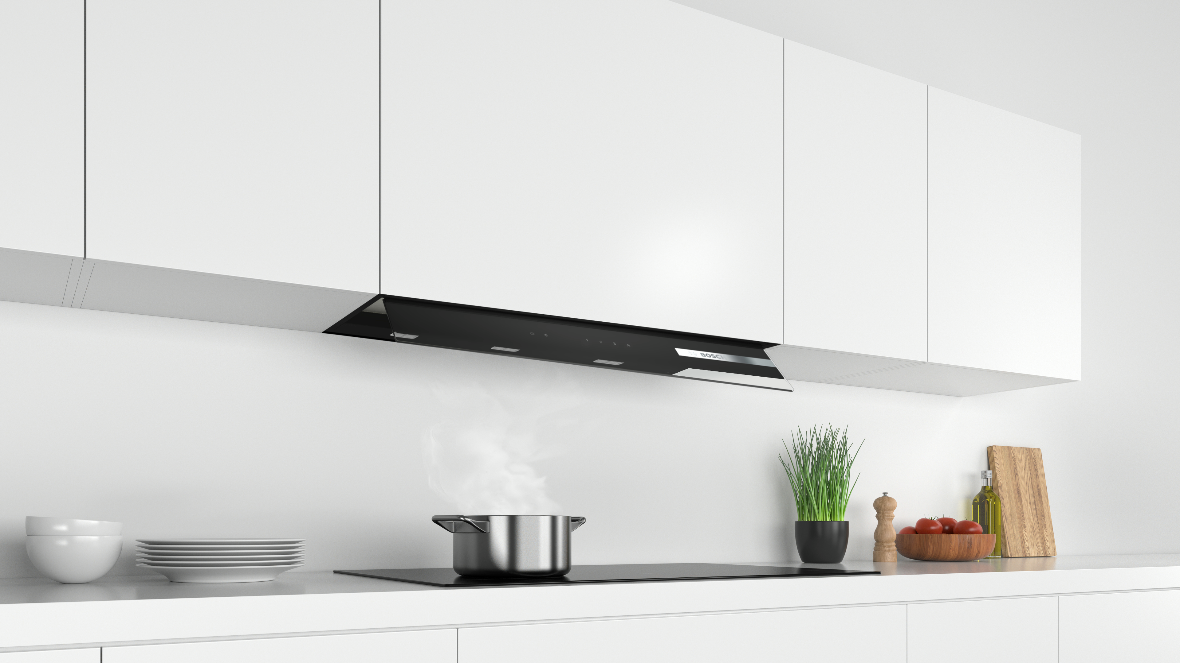 Cocina con una campana extractora negra y una olla en la estufa.