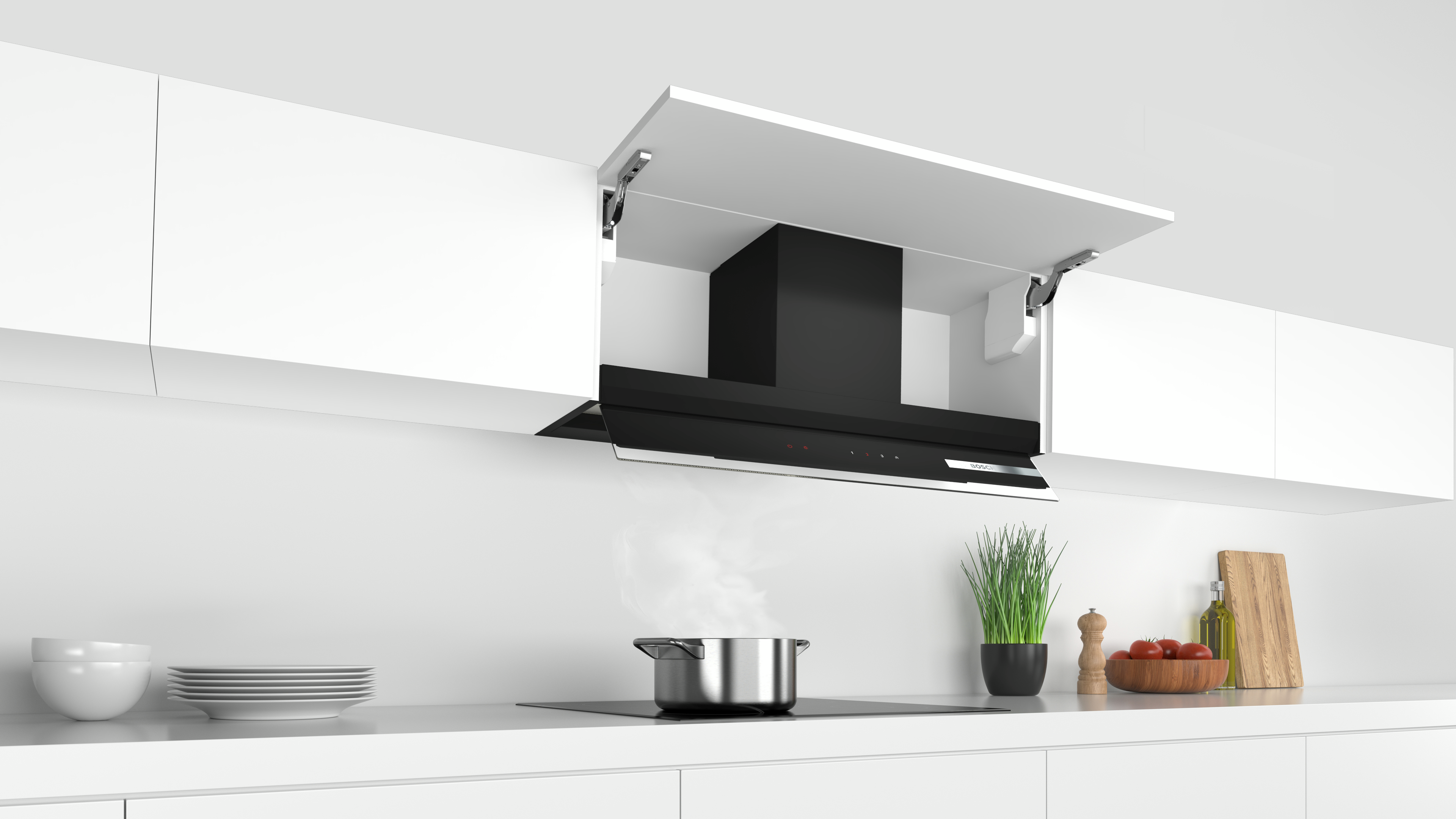 Configuración de cocina moderna con campana extractora negra sobre la vitrocerámica y armarios blancos.