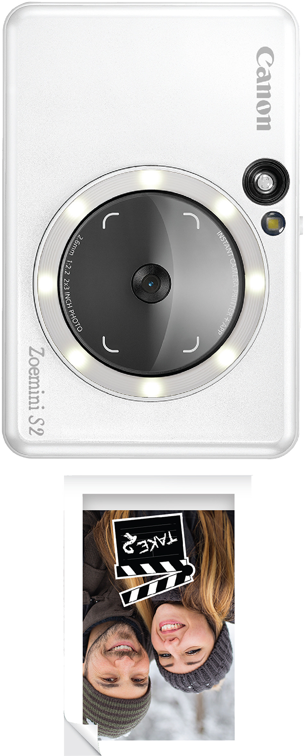 White Canon Zoemini S2 camera with a photo of a couple. The camera has a lens and a flash.