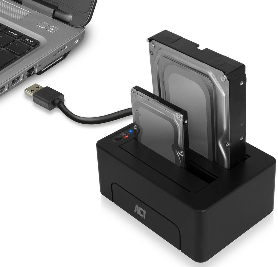 A black hard drive docking station with two inserted hard drives, connected to a laptop.
