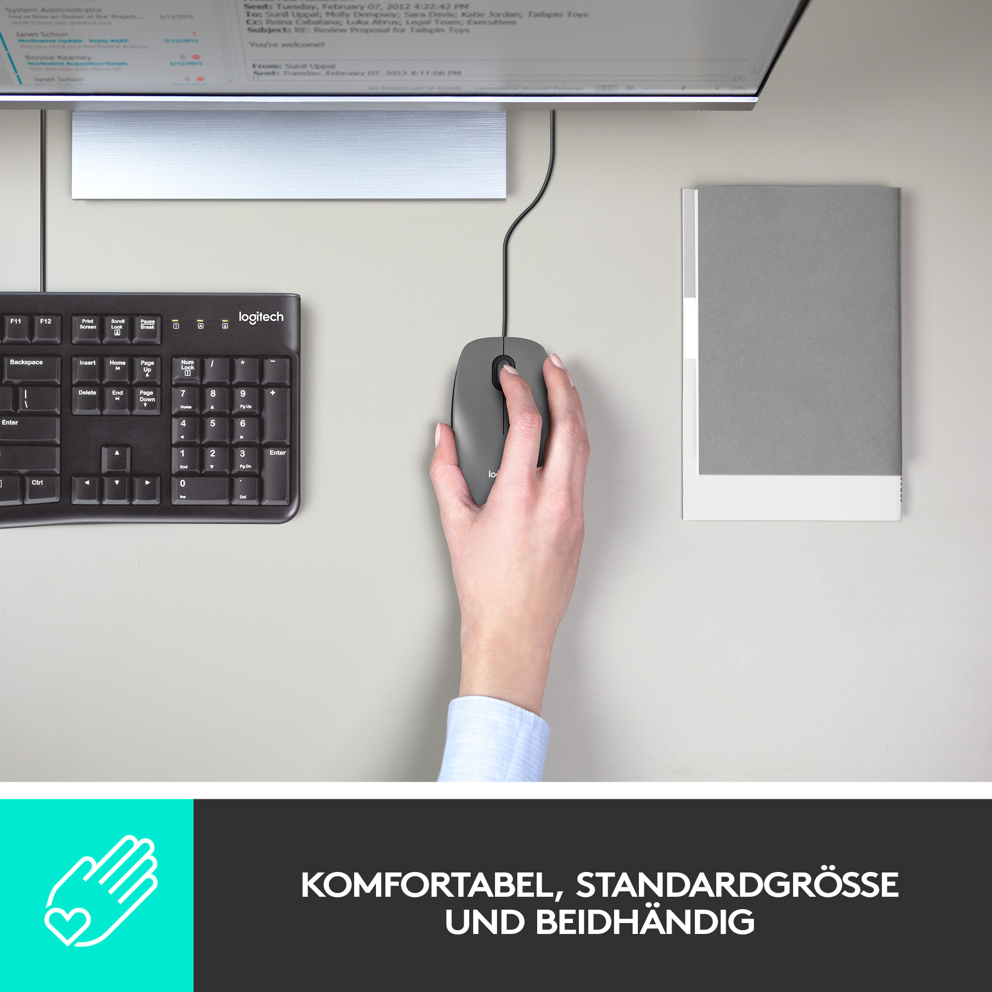Hand benutzt graue Maus neben Tastatur und Monitor. Text unten.