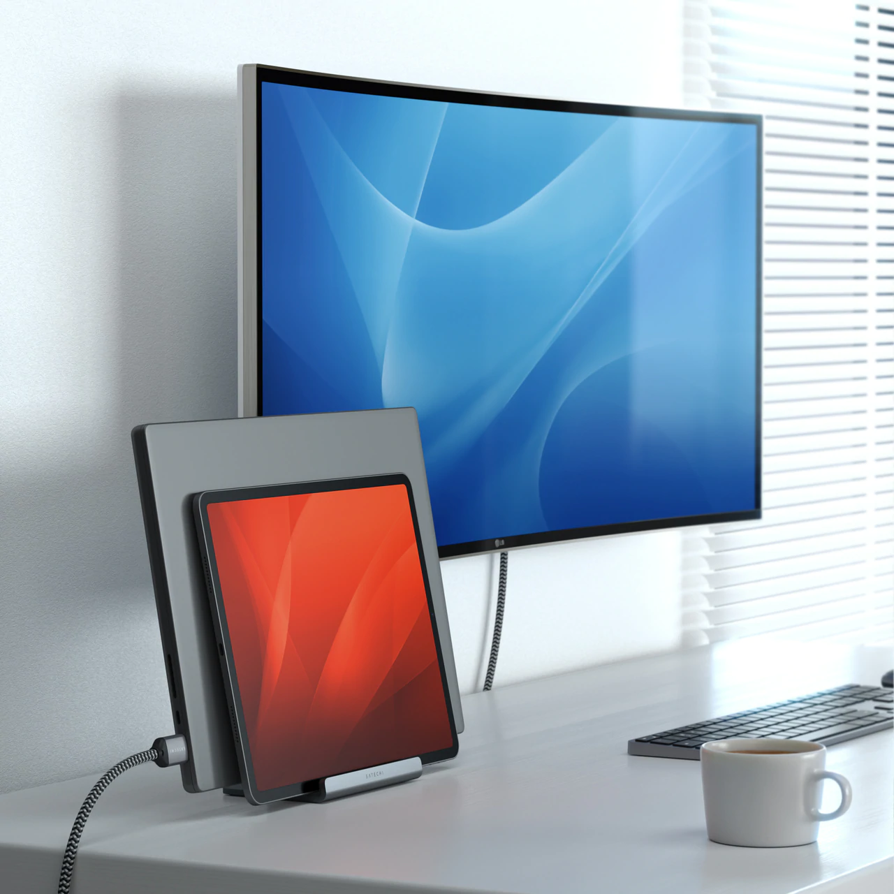 Schreibtisch mit Laptop, Tablet, Monitor und Kaffeetasse. Modernes Setup, weißer Hintergrund.