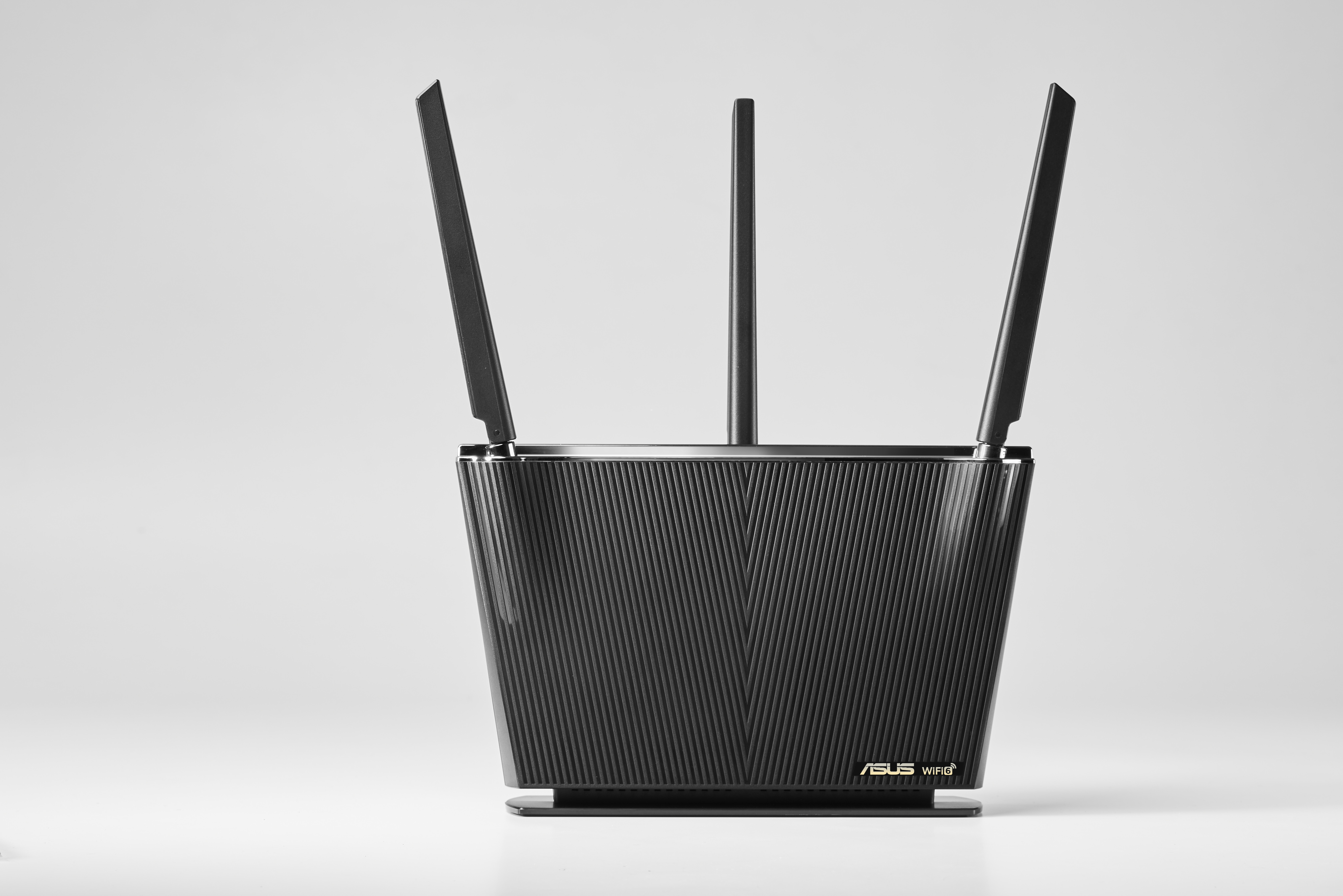 Black ASUS WiFi router with antennas, on white background.