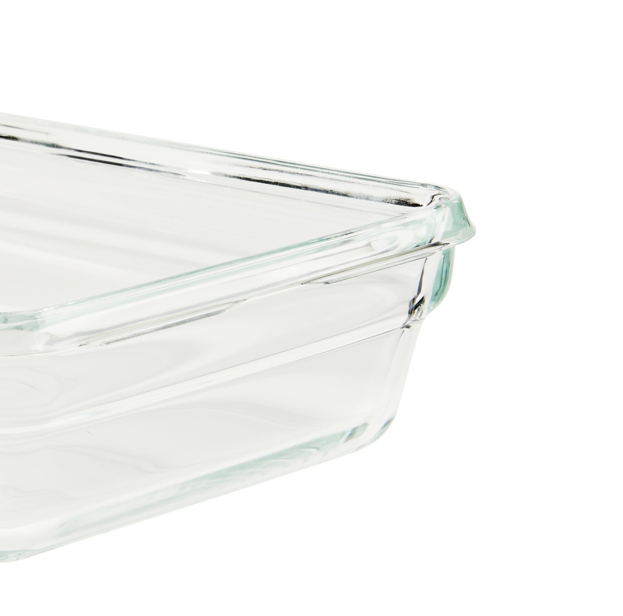Esquina de una fuente rectangular de vidrio transparente sobre una superficie blanca.
