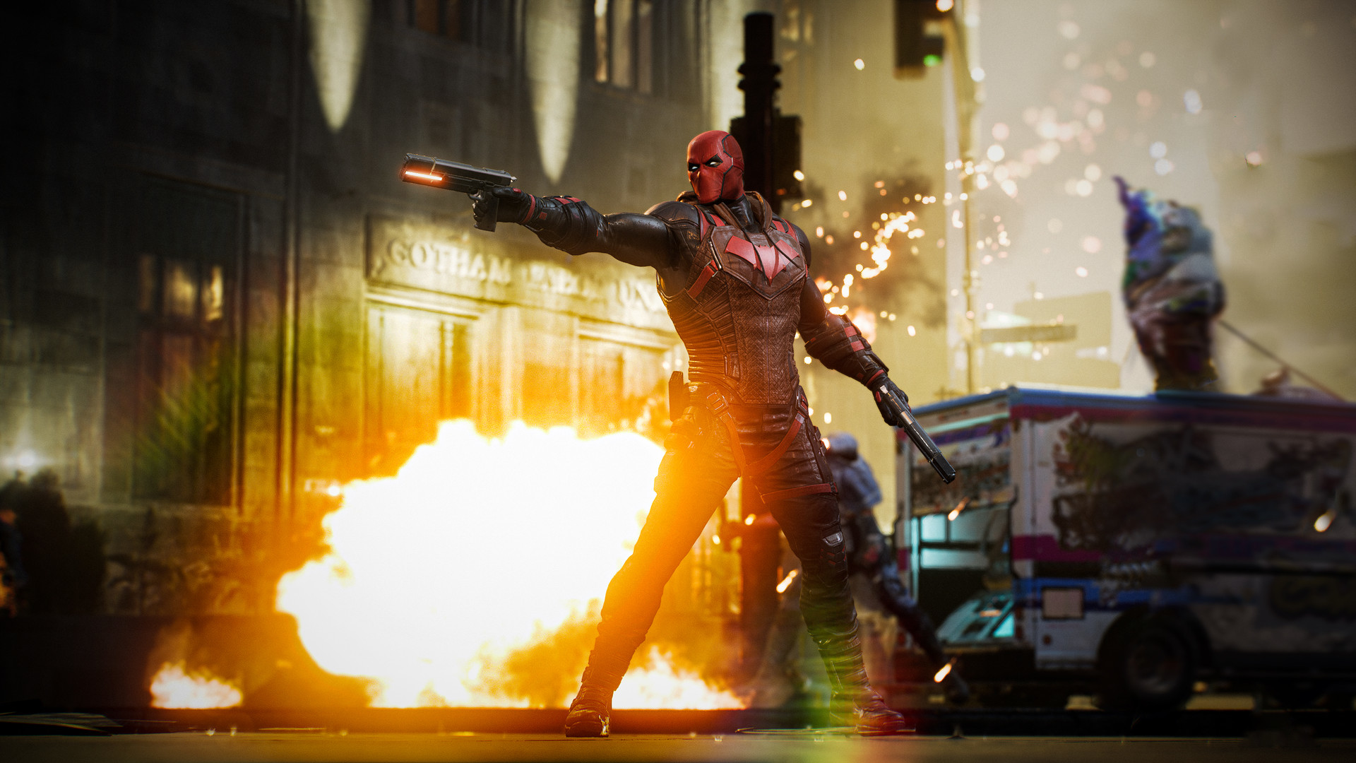 Red Hood mit zwei Waffen vor einem brennenden Gotham-Gebäude und einem Imbisswagen.