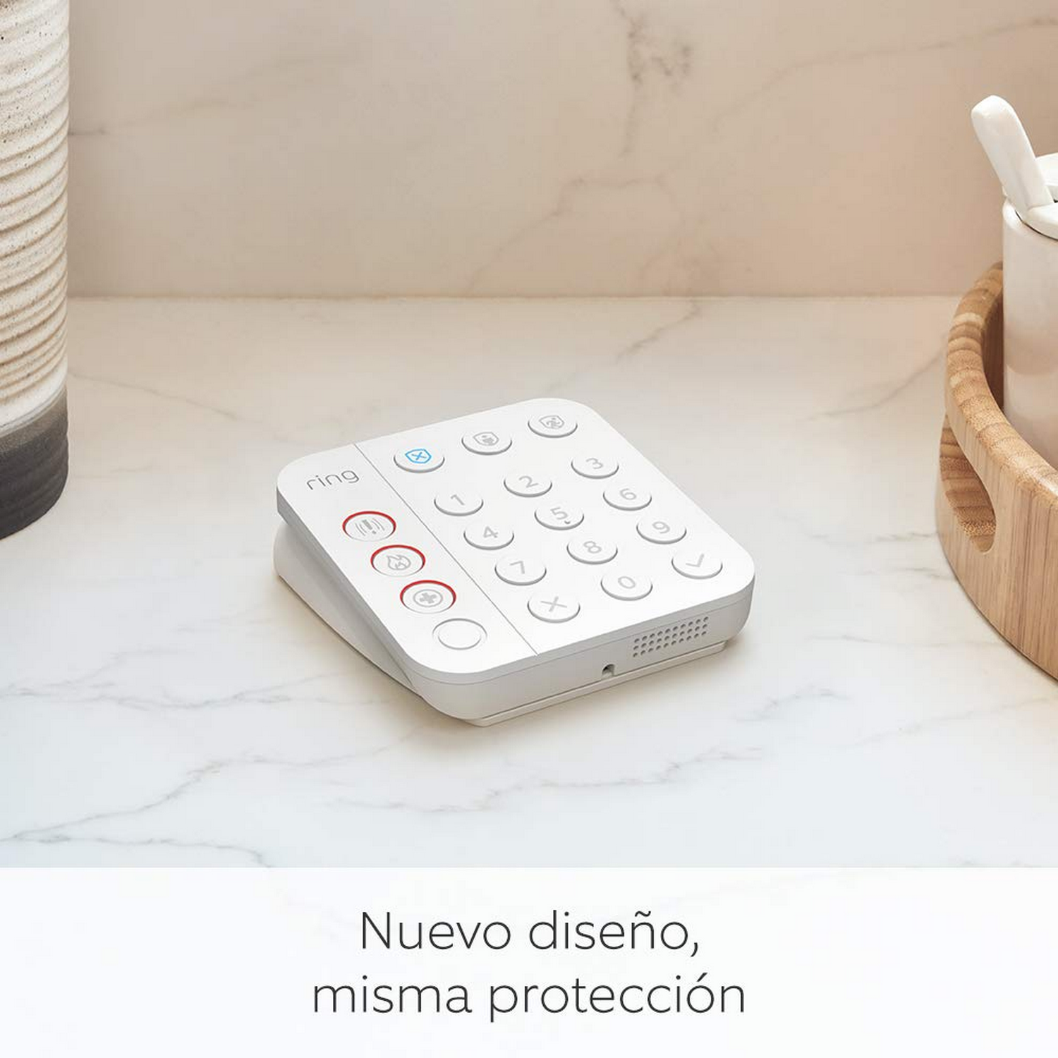 Teclado Ring blanco sobre superficie de mármol con bandeja de madera y recipiente cerámico en el fondo.