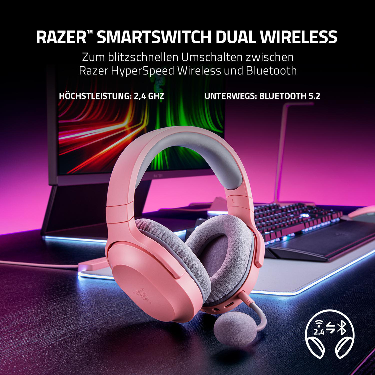 Pinke Razer-Funkkopfhörer auf einem Schreibtisch mit Tastatur und Monitor. Text oben.