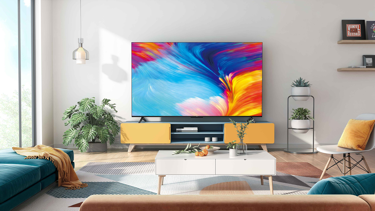 A living room with a large TV, a blue sofa, a white coffee table, and a yellow and brown rug.