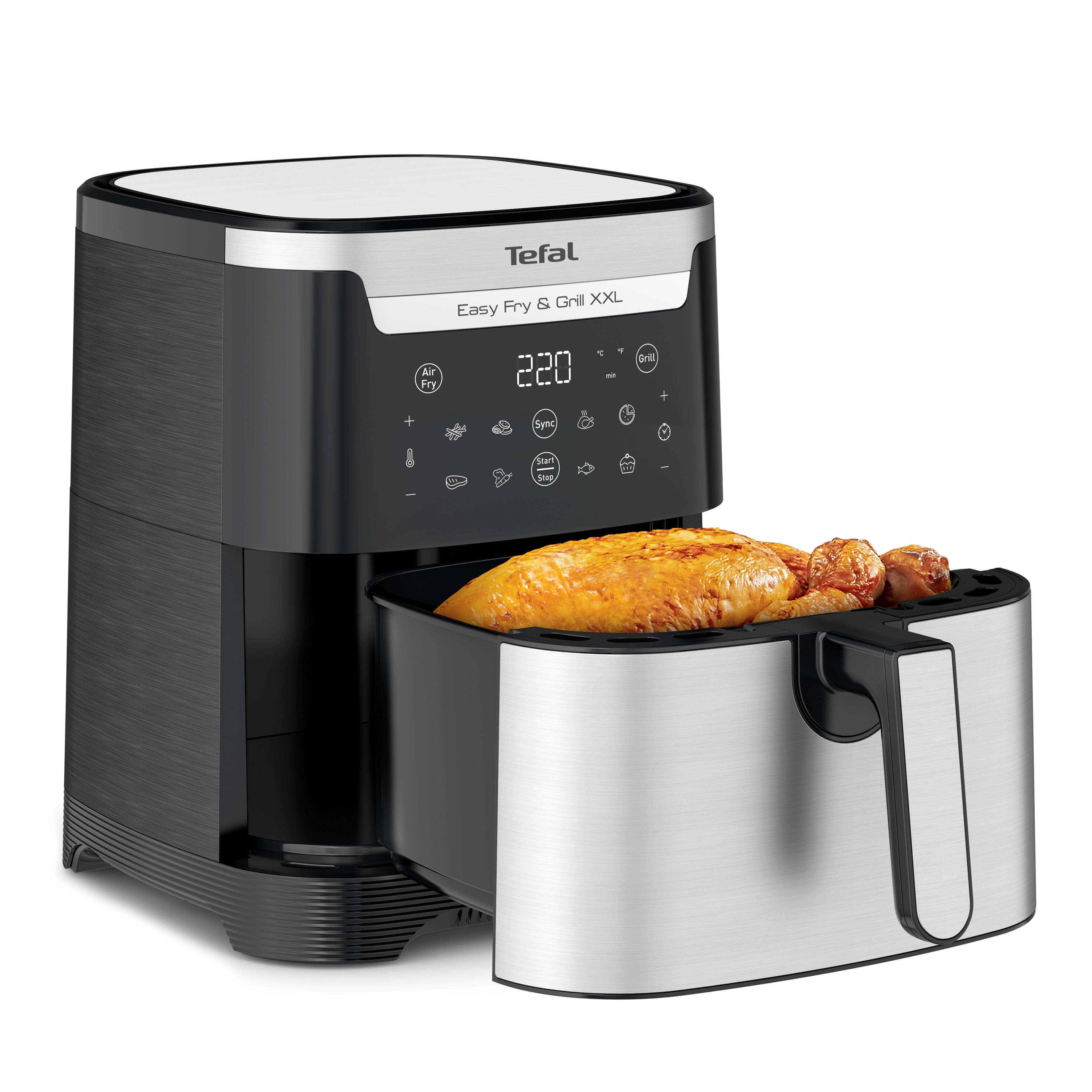 Tefal Heißluftfritteuse mit einem Huhn darin. Die Fritteuse ist schwarz und Edelstahl.