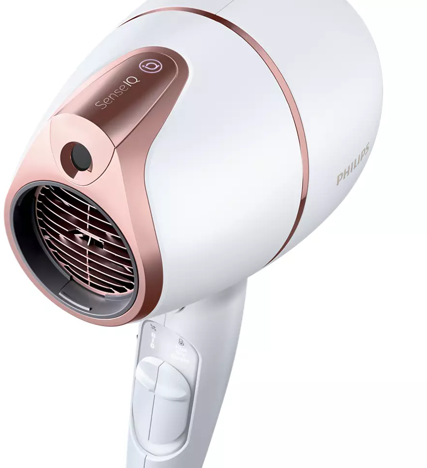 White hair dryer with rose gold accents. The handle shows settings. White background.