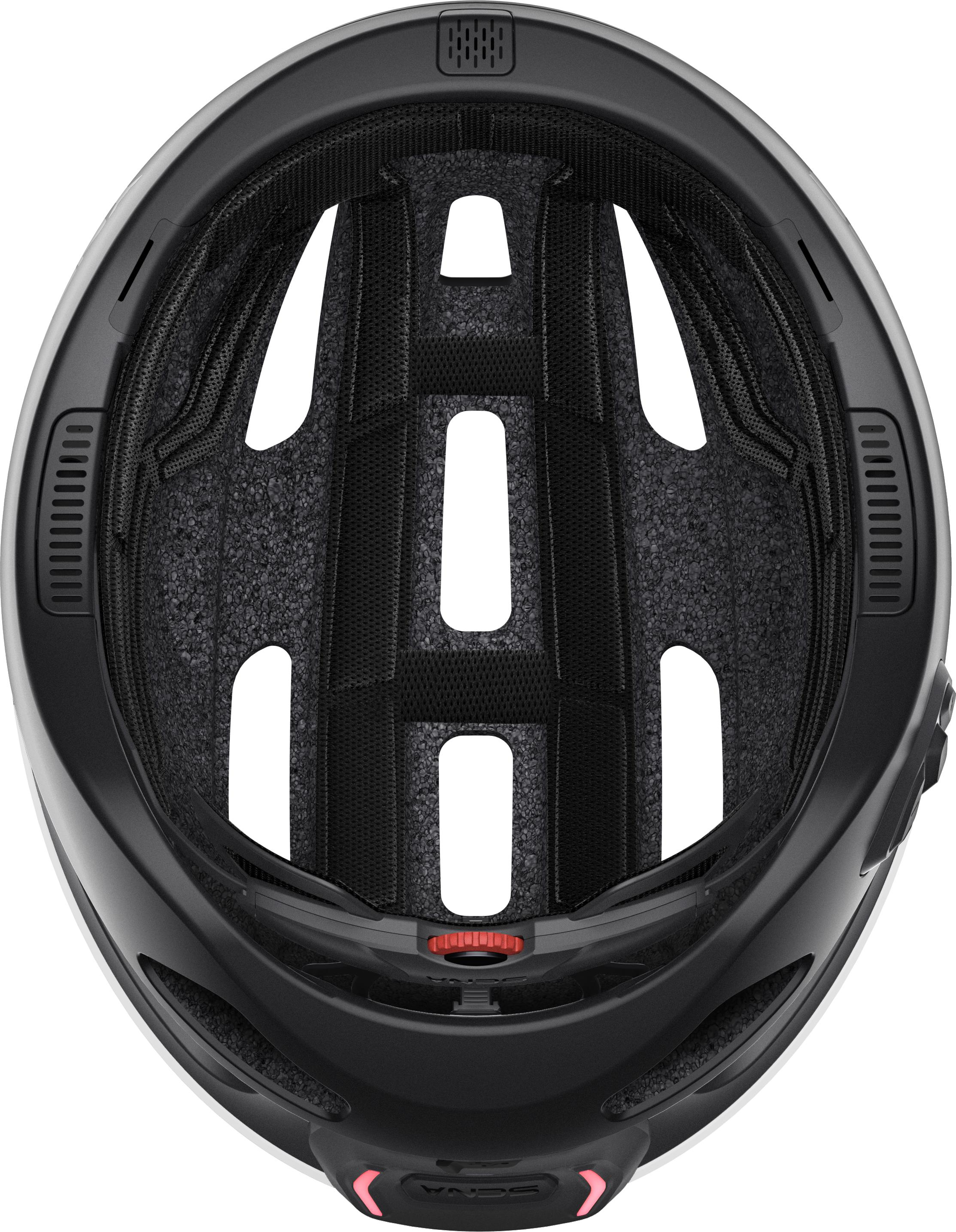 Draufsicht auf einen schwarz-weißen Fahrradhelm mit rotem Verstellknopf.
